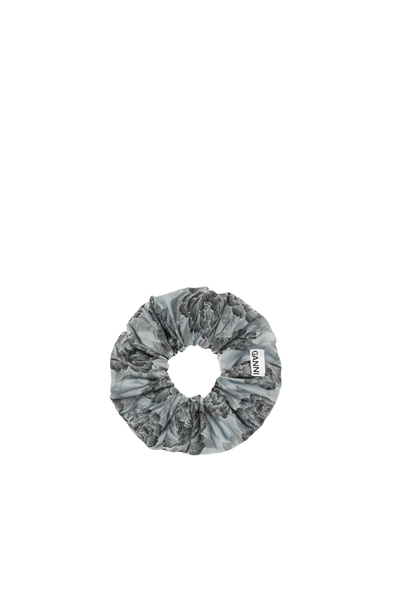 A Scrunchie hair tie from Ganni in blue and black flower pattern.